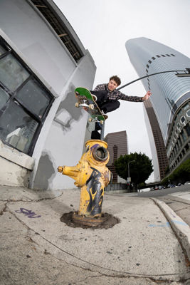 Normal View of a Skateboarder Jumping Over a Fire Hydrant