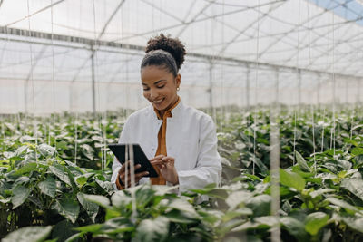 Person on a Tablet Registering Different Plants