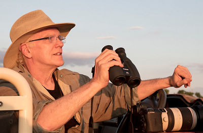 Candid shot of Rick Sammon holding his Canon binoculars