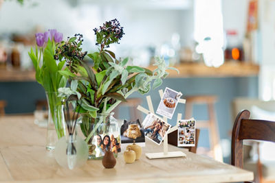 Flowers in a Vase Next to a Photo Collage
