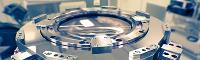 Large cylindrical metal part of a lithography industrial machine.