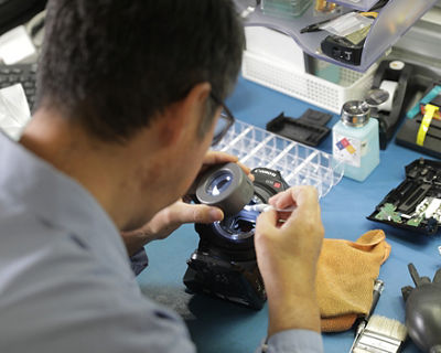 technician servicing a camera