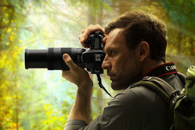 Man using viewfinder on camera