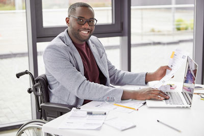 Man in wheelchair working on computer