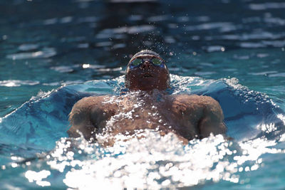 Swimmer in a Pool Swimming on Their Back