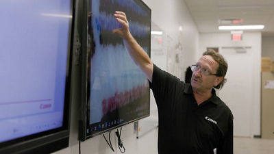 Person Pointing to a Screen