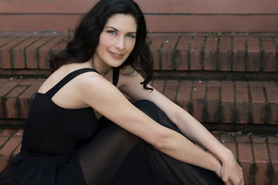 Photo of a woman sitting on stairs