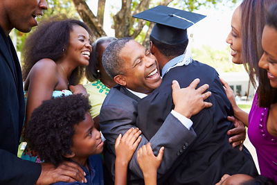 Graduate embracing his family