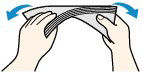 Hold the opposite corners and gently twist them in the opposite direction