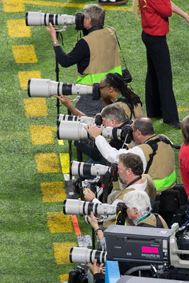 Canon's iconic white lenses and DSLR cameras alongside the sideline at The Big Game in Minnesota.