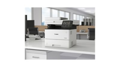 A Canon printer on an office desk.