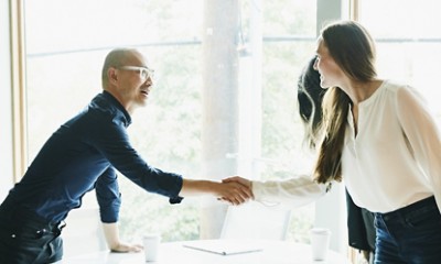 Businesspeople shaking hands in conference room