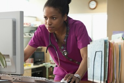 nurse looking at computer