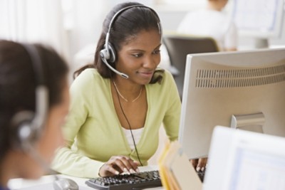 African businesswoman with headset at desk