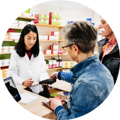 Pharmacist and clients at pharmacy counter