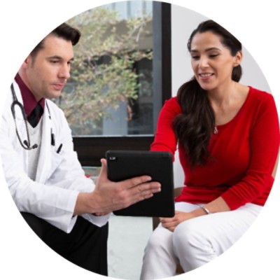 Male doctor showing woman something on tablet