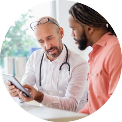 Male doctor showing a man something on a tablet