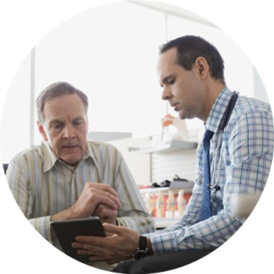 Doctor showing tablet to patient