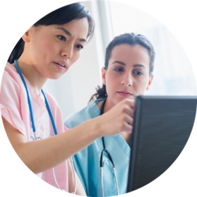 Two nurses looking at computer screen