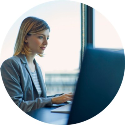 Woman typing on keyboard and looking at monitor