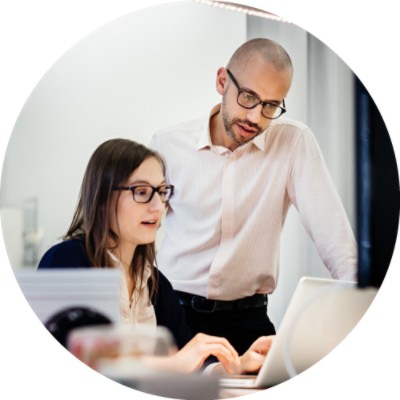 Man and woman discussing something on computer screen