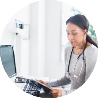 Doctor looking at tablet and computer