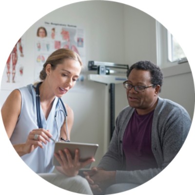 Doctor with patient pointing to tablet