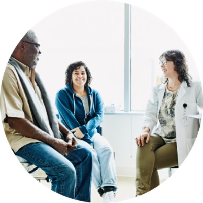 Three people talking in exam room