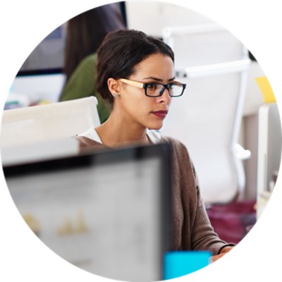 Woman in cubicle using computer