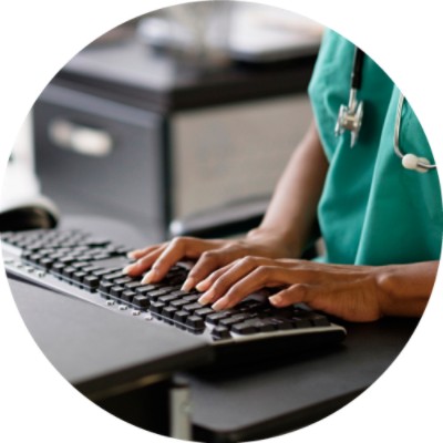 Hands typing on computer keyboard