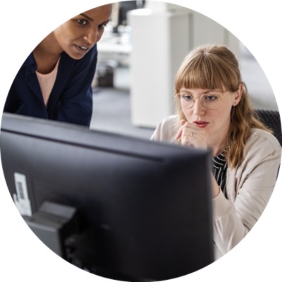 Two women looking at computer screen