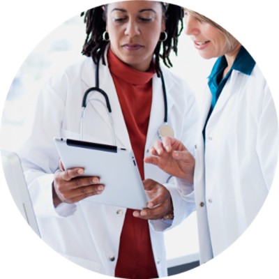 Two women talking and looking at tablet