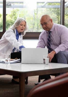Man and woman doctor looking at computer