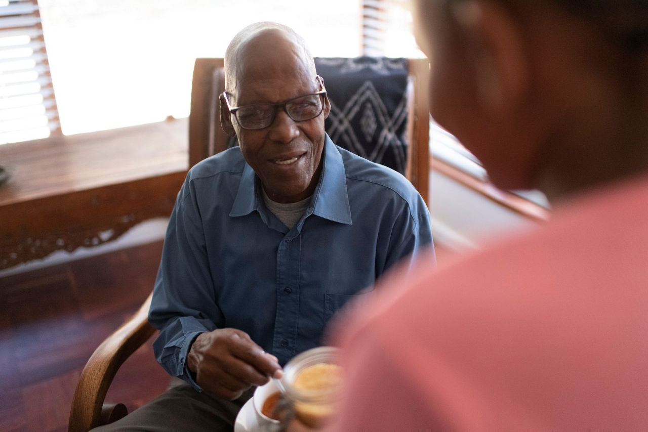 Granddaughter offers grandfather sugar for his tea