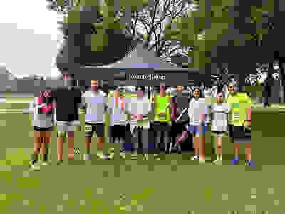5K run group shot under Constellation tent