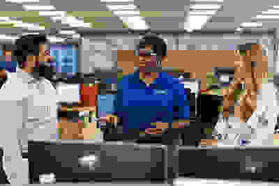 Three women smiling in an office setting