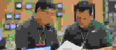Two men looking at files