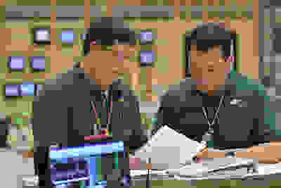 Two men looking at files