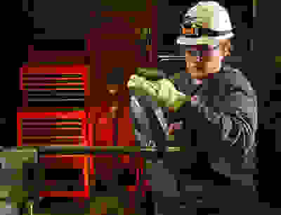 Woman holding machinery