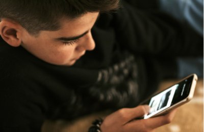 Boy looking at mobile device.