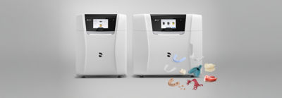 CEREC Primemill device with clear aligner and veneers in foreground.