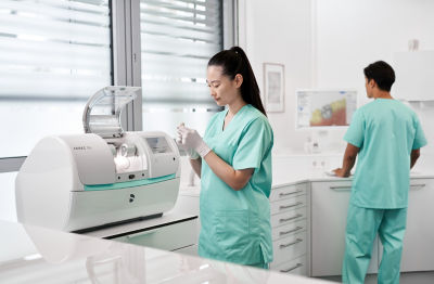 Dentist using a computer with DS Core cloud platform for digital dental workflows.