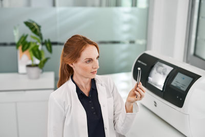 Dental professional accessing DS Core Care service and support tools on screen.