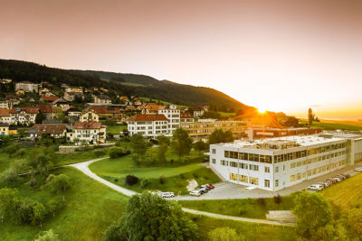 Residential and office buildings against a sunset and green fields. Text overlay reads "Healthy planet".