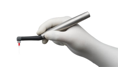 Hand holding the SmartLite Pro EndoActivator, a dental device used for cleaning and disinfecting root canals.