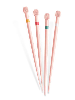 Close-up of five pink Conform Fit Gutta-Percha points with color-coded bands near the tips, standing upright on a light background.