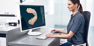 Female dental professional looking at lower-arch scan using inLab Software