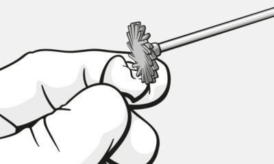 Polishing tool held by hand for finishing dental restorations