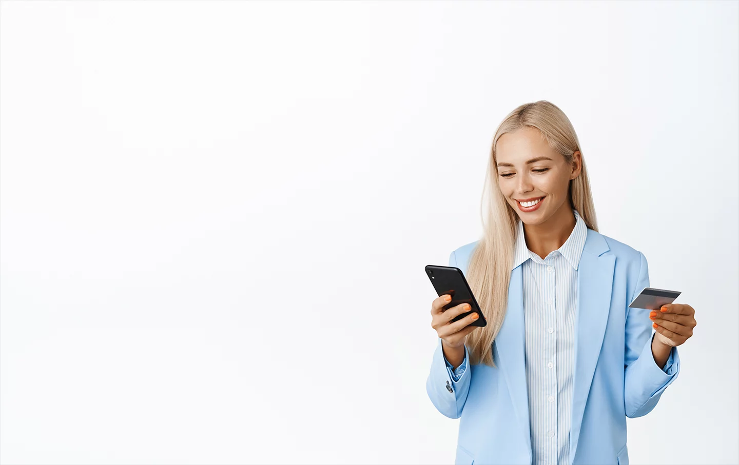 A happy woman using her smart phone to make an online purchase