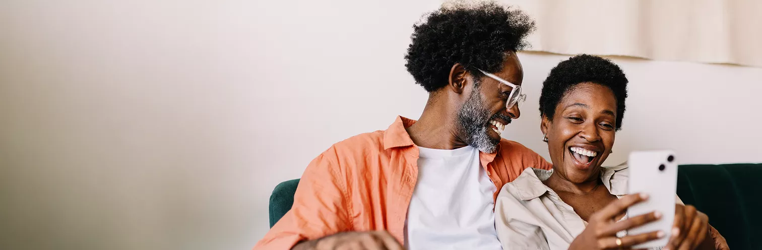 Couple looking at their phone together